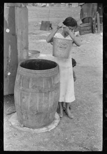 Untitled photo, possibly related to: San Antonio. The Mexican section. Water supply of Mexican family living on the outskirts of town. This water is brought from the city and is delivered by wagon