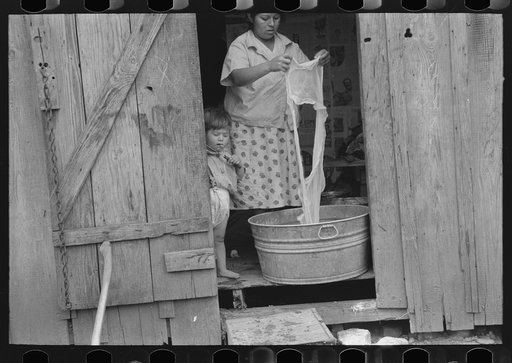Untitled photo, possibly related to: Mexican child on porch of house facing corral, San Antonio, Texas