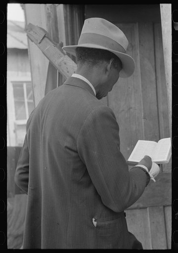 Untitled photo, possibly related to: Negro Preacher reading the scriptures to Negro man, San Antonio, Texas