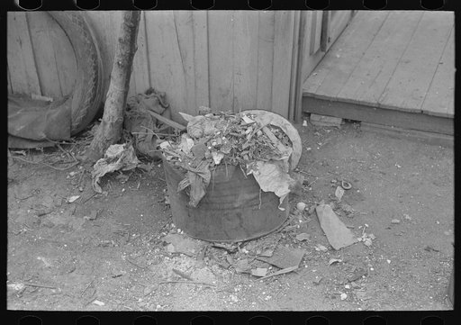 Untitled photo, possibly related to: Uncollected garbage and pot plants in back yard of Mexican house, San Antonio, Texas