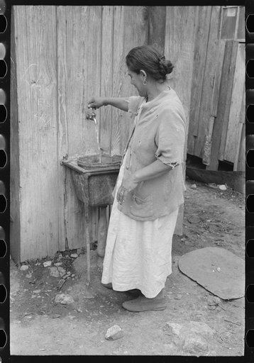 Untitled photo, possibly related to: San Antonio. The Mexican section. Water supply of Mexican family living on the outskirts of town. This water is brought from the city and is delivered by wagon