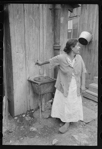 Untitled photo, possibly related to: San Antonio. The Mexican section. Water supply of Mexican family living on the outskirts of town. This water is brought from the city and is delivered by wagon