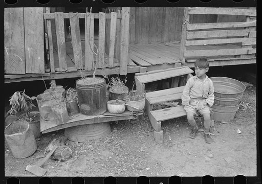 Mexican boy sitting on door step, San Antonio, Texas