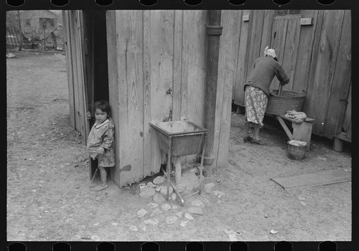 Mexican girl coming from privy, woman washing clothes, San Antonio, Texas