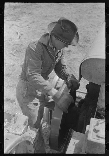 Untitled photo, possibly related to: Starting a tractor by starting the flywheel, El Indio, Texas