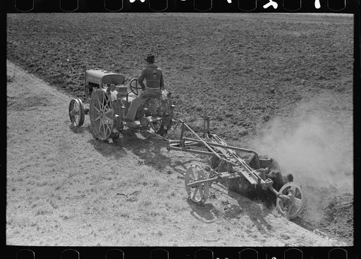 Breaking virgin soil with tractor and plow, El Indio, Texas