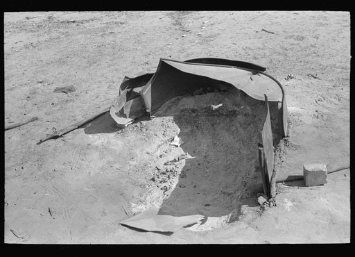 Guard for pit fire made out of fender of automobile, Crystal City, Texas, Mexican section