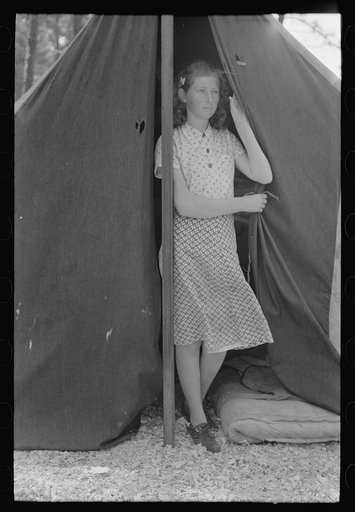 Daughter of migrant strawberry picker in doorway of tent home near Hammond, Louisiana