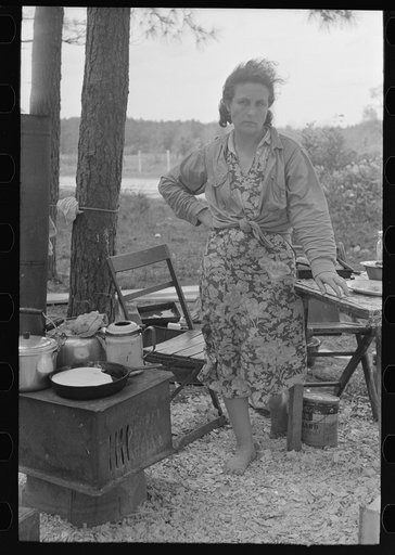 Migrant mother in front of outdoor stove near Hammond, Louisiana strawberry center