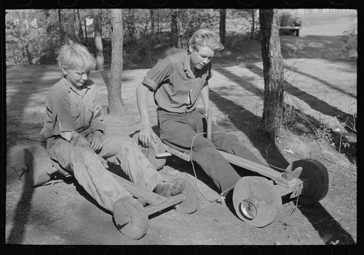 Migrant keymaker's children with homemade scooter, Jefferson, Texas