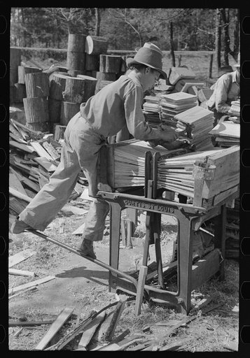 Young boy packing shingles at small mill near Jefferson, Texas
