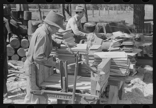 Young boy packing shingles at small mill near Jefferson, Texas