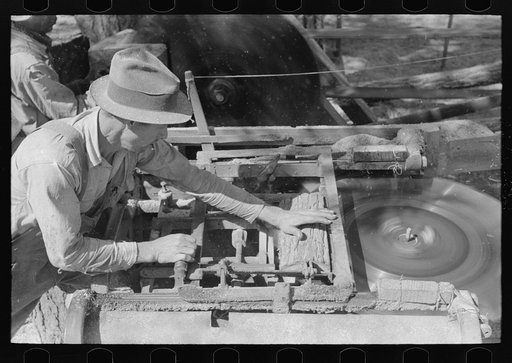 Sawing shingles by means of horizontal circular saw at small mill near Jefferson, Texas