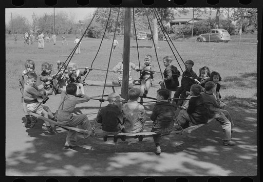Schoolchildren on circular swing, San Augustine, Texas