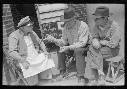 Two farmers talking to popcorn man, San Augustine, Texas