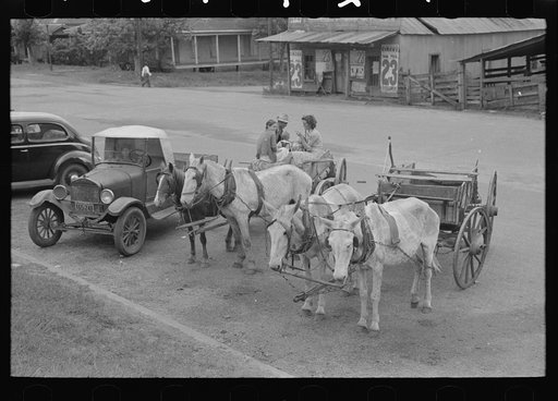 Farmers' vehicles parked near courthouse, Saturday afternoon, San Augustine, Texas