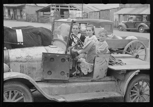 Farmer's children sitting in farm truck, Saturday afternoon, San Augustine, Texas