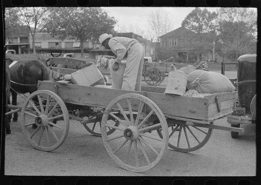 Negro farmer loading supplies into his wagon, Saturday afternoon, San Augustine, Texas