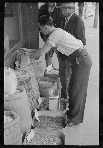 Clerk putting up seed, San Augustine, Texas