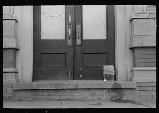 Ice melting on doorstep before bank opens, San Augustine, Texas