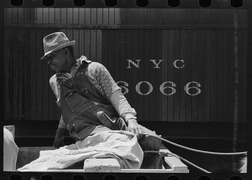 Untitled photo, possibly related to: Negro strawberry farmer on top of wagon in front of refrigerator car, Hammond, Louisiana