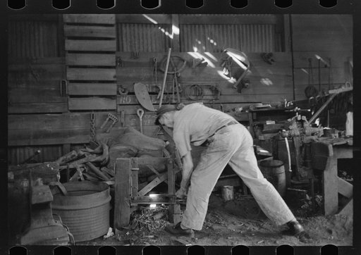 Untitled photo, possibly related to: Blacksmith at work in his shop, San Augustine, Texas