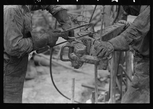 Detail of oil workers repairing pipe wrench; notice gloves. Oil well, Kilgore, Texas