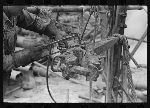 Untitled photo, possibly related to: Detail of oil workers repairing pipe wrench; notice gloves. Oil well, Kilgore, Texas