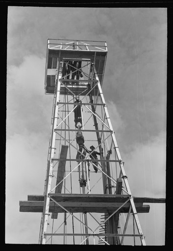 Untitled photo, possibly related to: Top of derrick showing gin pole, crow's nest, crown block, traveling block, elevator and cat line. Oil well, Kilgore, Texas