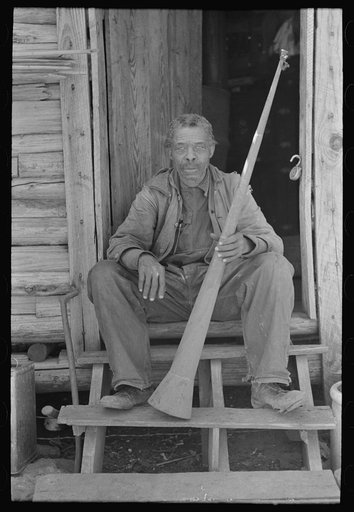 Old Negro (former slave) Willis Winn with horn with which slaves were called. Near Marshall, Texas
