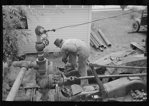 Untitled photo, possibly related to: Working on steam drilling engine, oil well, Kilgore, Texas