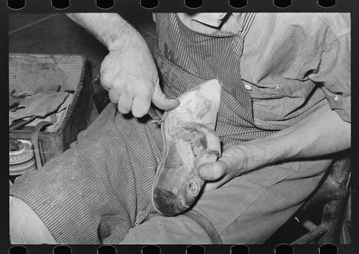 Trimming edge of inner sole. Boot shop, Alpine, Texas