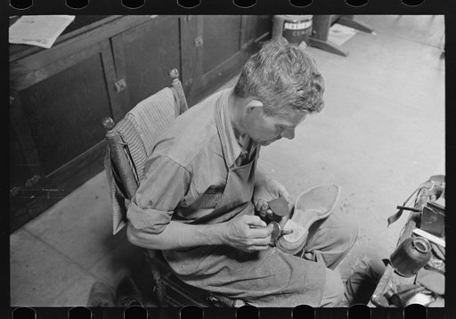 Applying glue to heel before putting on another piece of leather. Bootmaking shop, Alpine, Texas