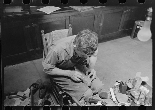 Untitled photo, possibly related to: Applying glue to heel before putting on another piece of leather. Bootmaking shop, Alpine, Texas