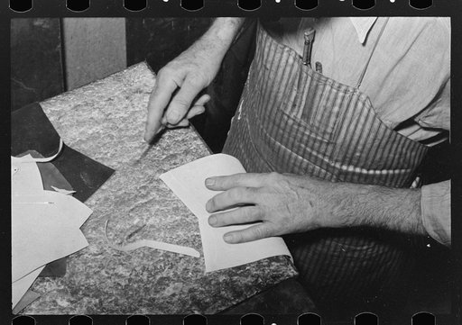 Untitled photo, possibly related to: Skiving part of upper which fits onto heel of boot. Skiving is done in order to have small seams. Bootmaking shop, Alpine, Texas