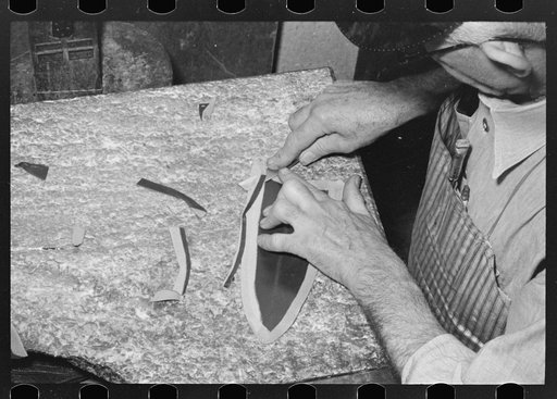 Skiving part of upper which fits onto heel of boot. Skiving is done in order to have small seams. Bootmaking shop, Alpine, Texas