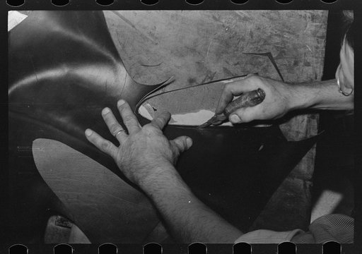 Untitled photo, possibly related to: Outside grooving of inner sole in process of making welt. Bootmaking shop, Alpine, Texas