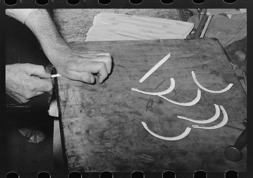Crimping beading by hand to fit uppers of boots in boot shop. Alpine, Texas