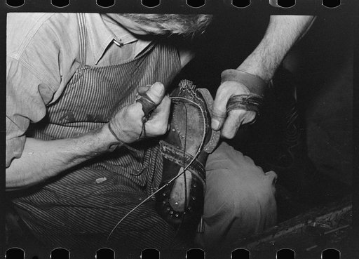 Sewing foot of boot onto sole of Goodyear welt system. Cowboy boot shop, Alpine, Texas