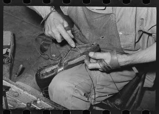 Sewing foot of boot onto sole of Goodyear welt system. Cowboy boot shop, Alpine, Texas