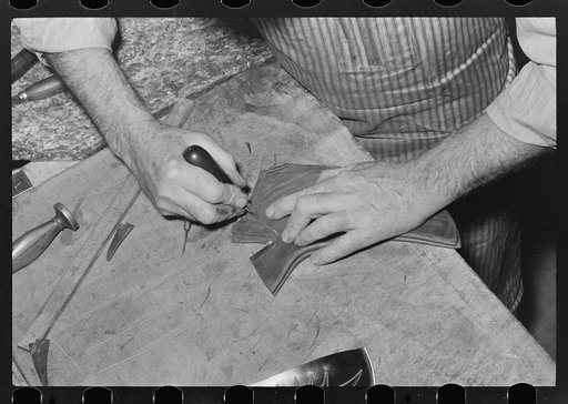 Trimming lower part of boot. Cowboy bootmaking shop, Alpine, Texas