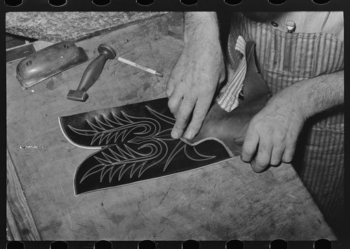 Fitting upper to lower part of boot. Bootmaking shop, Alpine, Texas