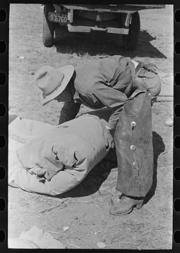 Untitled photo, possibly related to: Tying the bedroll. Bunk of the cowboy on the range. Cattle ranch near Marfa, Texas