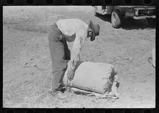 Untitled photo, possibly related to: Tying the bedroll. Bunk of the cowboy on the range. Cattle ranch near Marfa, Texas