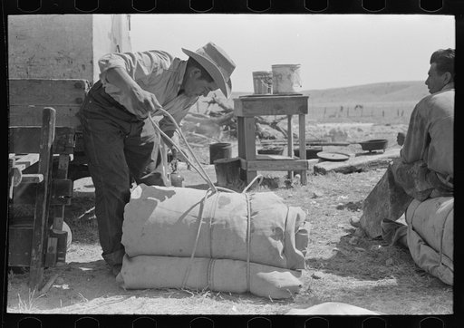 Untitled photo, possibly related to: Cowboy tying up bedroll. Cattle ranch near Marfa, Texas