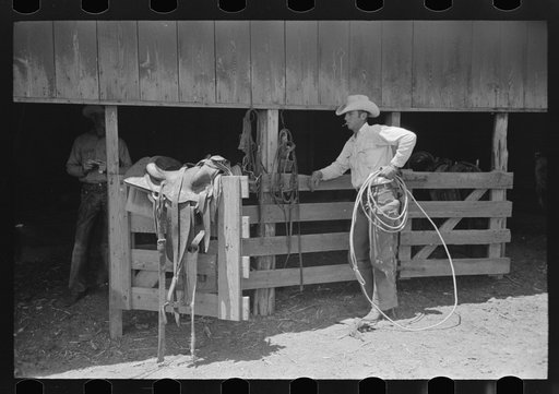 Cowboy in front of the saddle room on cattle ranch near Spur, Texas
