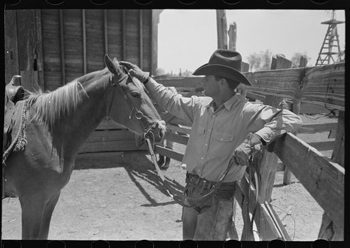 Cowboy petting his horse. Cattle ranch near Spur, Texas