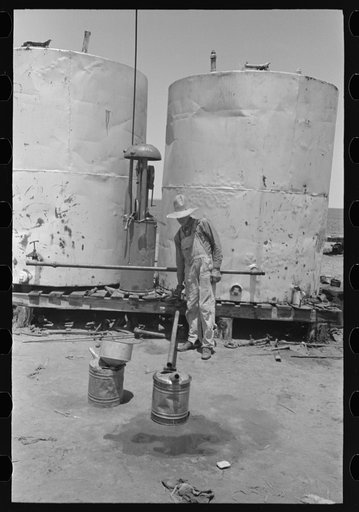 Untitled photo, possibly related to: Pouring gasoline into tractor, large farm near Ralls, Texas. Man is day laborer