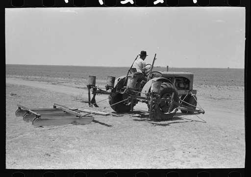 Untitled photo, possibly related to: Tractor with planter and go-devil attached, large farm near Ralls, Texas