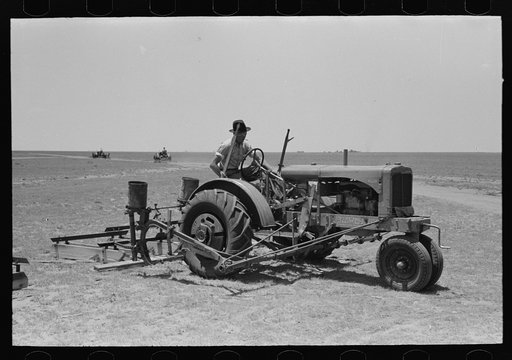 Tractor with planter and go-devil attached, large farm near Ralls, Texas